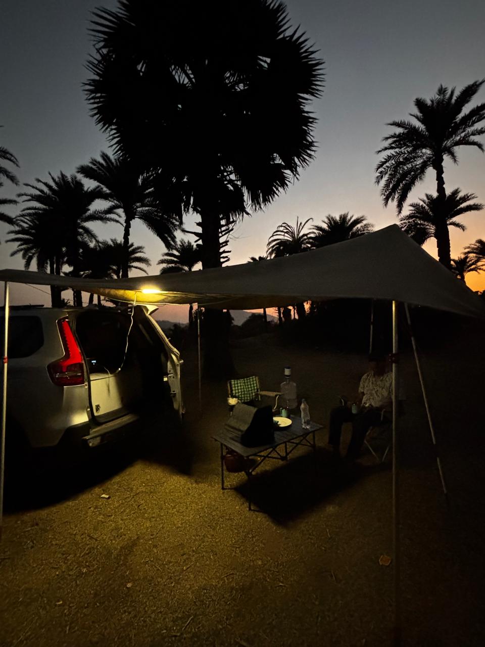 Night camping beside a vehicle